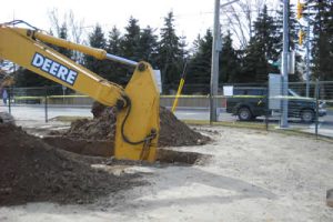 Image of a backhoe digging a hole