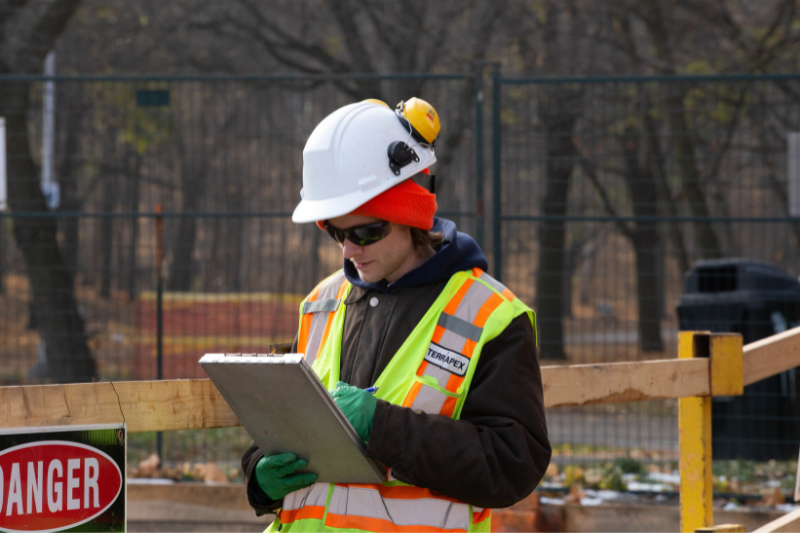 Image of a man taking notes at a construction site