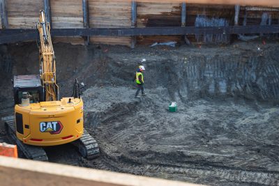 Image of an employee walking in a construction site.