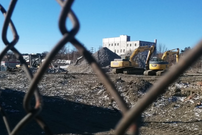 Image of a brownfield site through fence