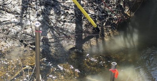 Image of a hydrogeology field test in a waterway.