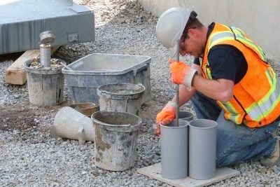 Image of a worker conducting site inspection and testing.