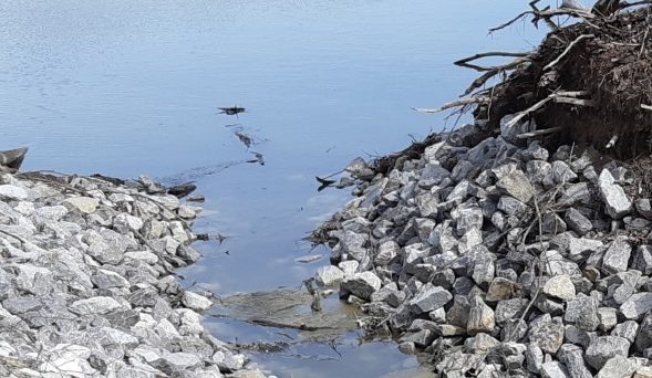 Image of waterway with rocks and debris.