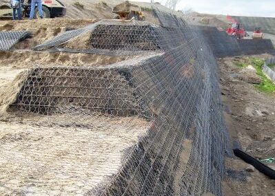 Image of onsite geotechnical engineering with workers assessing process and large equipment onsite.