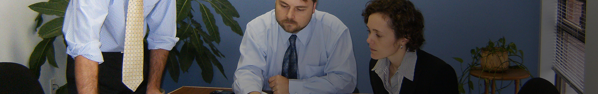 Career page header image consisting of three corporate workers at a boardroom table.