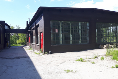 Image of old building with large windows and land slated for Brownfield redevelopment