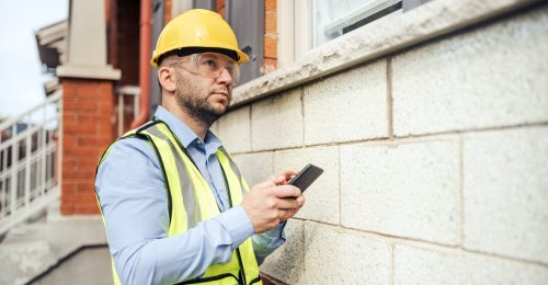 Image of person in safety equipment conducting Pre-Construction Condition Assessments