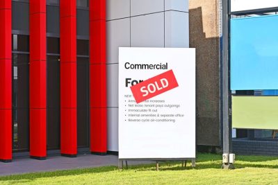 Red sold sign outside of a commercial property.